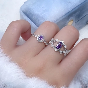 Close-up of two elegant purple zircon rings on a velvet box with a luxury aesthetic