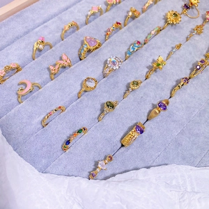Close-up of gold-plated enamel rings with zircon butterfly and flower designs
