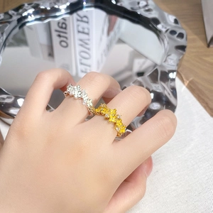 Mint green enamel petal open rings with zircons shown on a hand in a stylish setting