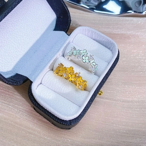 Mint green and yellow enamel flower open rings in a black jewelry gift box