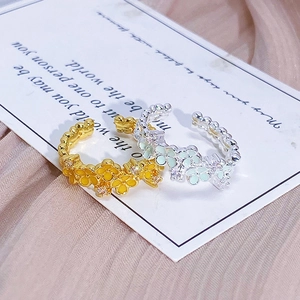 Mint green and yellow enamel flower open rings with shimmering zirconia accents