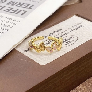 Detail shot of vintage butterfly open ring with pink enamel and gold plating