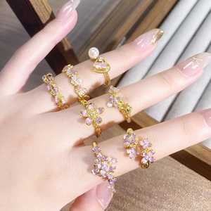 Vintage gold ring set with purple enamel flowers, pearls, and butterfly charms