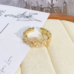 Detailed close-up of a vintage floral enamel ring featuring gold base and pink petals