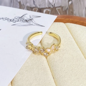 Detailed macro view of vintage gold flower enamel butterfly ring with zirconia crystals