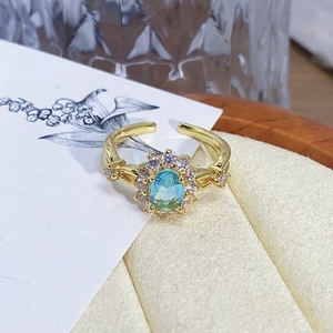 Macro shot of vintage floral gold ring with blue stone and white crystals