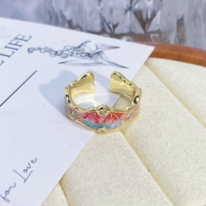 Close-up of vintage flower enamel open ring with pink and blue relief in jewelry box