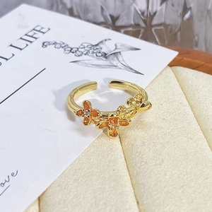 Detailed macro view of vintage gold flower enamel open ring with small zircons