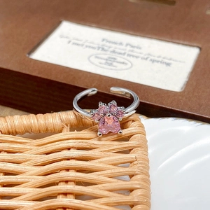 Macro shot of silver adjustable cat paw ring featuring heart-shaped pink zircon stones