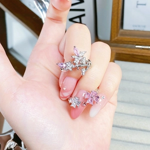 Detail of silver open ring with pink marquise zircon and butterfly floral setting