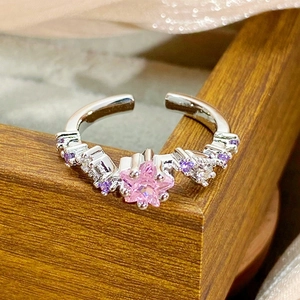 Macro view of pink star zircon ring with purple accents and polished silver band