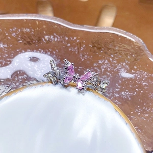 Macro shot of butterfly open ring featuring pink marquise-cut cubic zirconia and silver base