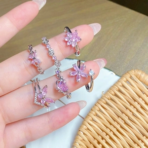 Detailed view of six-piece ring set featuring pink zircon butterflies and floral designs