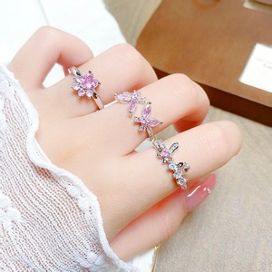 Detailed macro view of pink zircon heart and butterfly stackable rings for women