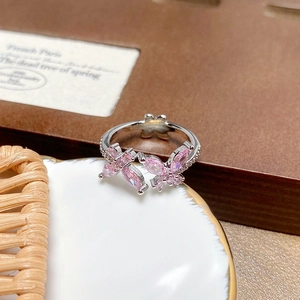 Detail of pink zircon butterfly ring with sparkling stones on silver open band