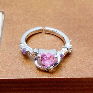 Detailed close-up of pink heart-shaped crystal ring with purple stones and silver finish