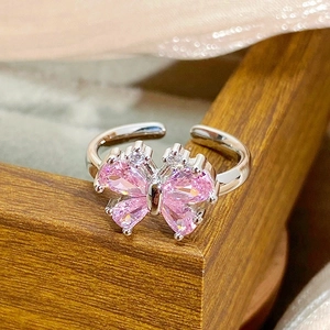 Close-up of pink zircon butterfly ring with silver adjustable band and crystal stones