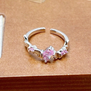 Detailed macro view of an adjustable silver ring with pink zircon butterfly element