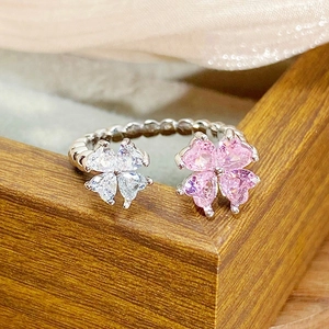 Close-up of adjustable silver ring with pink and white heart-shaped clover crystals