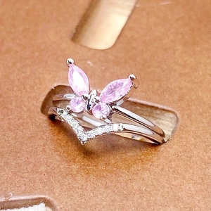 Detail of pink zircon butterfly ring with double-layered silver band and small diamonds