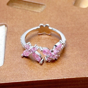 Detailed macro view of pink zircon butterfly adjustable ring with side crystal accents