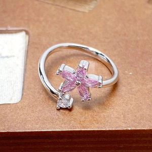 Detailed macro view of pink zircon flower and crystal stone on a silver adjustable ring