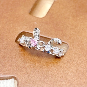 Detail of pink heart zircon ring with butterfly motif and pavé stones on a display card