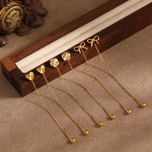 Three pairs of gold titanium Mickey mouse and bow windmill style long thread earrings