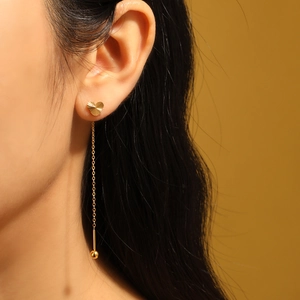 Elegant gold heart earrings with sunburst texture and long delicate chain ear wire