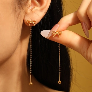 Elegant gold bow tassel earrings with long metal chains and small beads for women