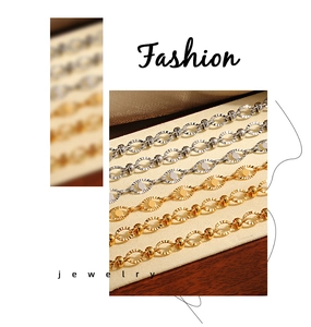 Close-up of gold and silver titanium steel bracelets with textured oval links and beads