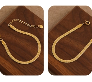 Detail of PVD gold herringbone chain bracelet with K18 engraving and lobster clasp