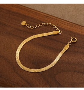Detailed macro view of a gold PVD plated stainless steel herringbone snake chain bracelet