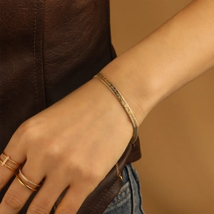 Luxurious gold PVD plated stainless steel snake chain bracelet on a model's wrist