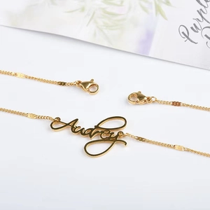 Custom gold Audrey name pendant necklace with elegant script design on white background