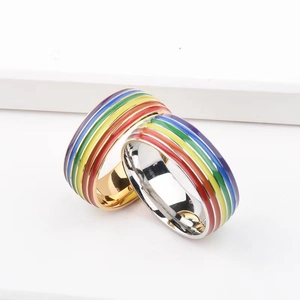 Rainbow enamel striped rings in gold and silver stainless steel finish on white background