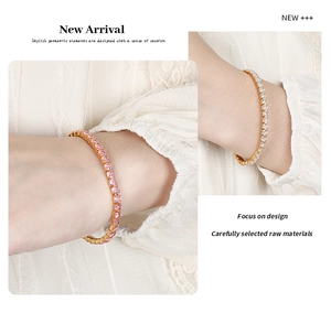 Close-up of gold tennis bracelets featuring pink and white round-cut zircon stones