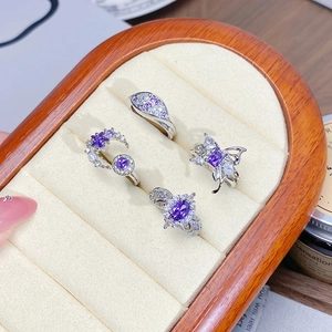 Detail view of silver rings set with purple zircon butterflies and crescent moon designs