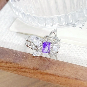 Macro detail of silver butterfly ring with purple zircon and adjustable open band