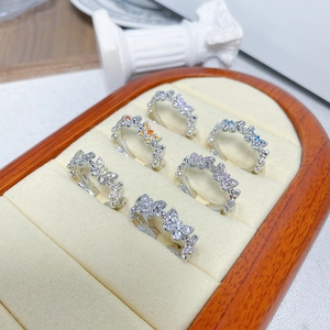 Detailed view of colorful zircon butterfly rings arranged on a beige velvet jewelry tray