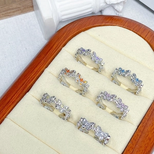 Macro view of six colorful zircon butterfly rings in a velvet jewelry display box