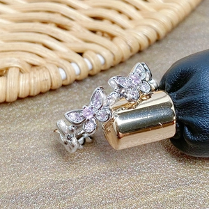 Detailed macro shot of the silver butterfly ring with sparkling pink zircon wing inlay