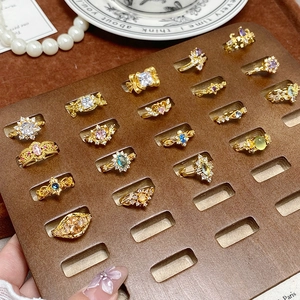 Bagues vintage géométriques avec zircons colorés sur un plateau à bijoux de qualité