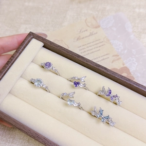 Set of six purple and blue zircon butterfly open rings in a luxury jewelry box display