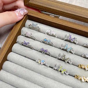 Elegant butterfly and bow rings with colorful cubic zirconia in a jewelry box