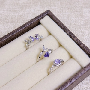 Three-piece set of silver open rings with purple daisies, butterflies, and moon zircon motifs