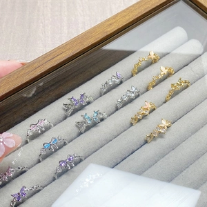 Macro detail of butterfly rings with multicolored cubic zirconia in a jewelry box