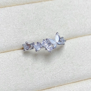 Macro shot of silver butterfly ring with shimmering zircon clusters and shell wings
