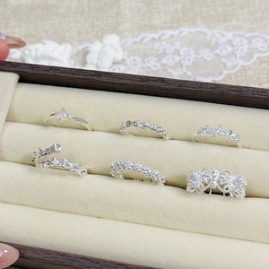 Set of six silver zircon rings featuring minimalist designs in a velvet display box