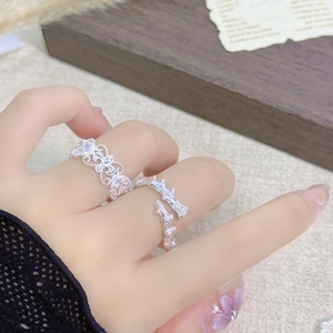 Detailed shot of silver lace zircon ring and bamboo textured adjustable ring on finger